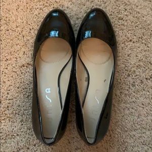 Shiny, black leather, half an inch heels.